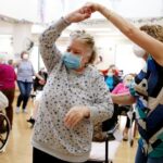 Residents and staff gather during an Easter concert for vaccinated residents at the Ararat Nursing Facility on April 1, 2021 in Los Angeles.  The concert was the first social event at the facility since the beginning of the pandemic.