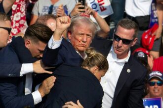 Republican candidate Donald Trump is seen with blood on his face surrounded by secret service agents as he is taken off the stage at a campaign event at Butler Farm Show Inc. in Butler, Pennsylvania, July 13, 2024. Donald Trump was hit in the ear in an apparent assassination attempt by a gunman at a campaign rally on Saturday. Sunday, Mississippi State Auditor Shad White called for U.S. Congressman Bennie Thompson to resign after one of his staffers posted support for the would be assassin.