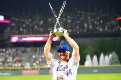 New York Mets first baseman Pete Alonso poses for photographs with the winners trophy following his victory in the 2021 MLB Home Run Derby.