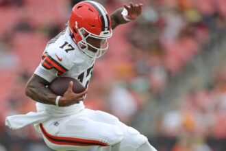 Cleveland Browns quarterback Dorian Thompson-Robinson (17) hurdles Green Bay Packers safety Tyler Coyle (24) on his way to a first down during the second half of an NFL preseason football game at Cleveland Browns Stadium, Saturday, Aug. 10, 2024, in Cleveland, Ohio.