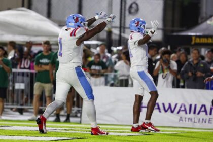 Jaden Sutton (1) and Kristian Tate (81) of the Delaware State Hornets gesture to the crowd after a touchdown during the second half of the game against the Hawaii Rainbow Warriors at the Clarence T.C. Ching Athletics Complex on August 24, 2024 in Honolulu, Hawaii.