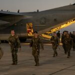 U.S. Marines with the 1st Battalion, 6th Marine Regiment, 2d Marine Division, disembark from a C-130 Hercules at Naval Station Guantanamo Bay, Cuba, on Feb. 1, 2025. The Marines have been deployed there as the Trump administration begins flights to Guantanamo Bay to detain up to 30,000 people who lack U.S. legal status. (U.S. Navy photo by Jovi Prevot)