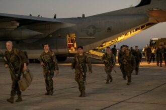 U.S. Marines with the 1st Battalion, 6th Marine Regiment, 2d Marine Division, disembark from a C-130 Hercules at Naval Station Guantanamo Bay, Cuba, on Feb. 1, 2025. The Marines have been deployed there as the Trump administration begins flights to Guantanamo Bay to detain up to 30,000 people who lack U.S. legal status. (U.S. Navy photo by Jovi Prevot)