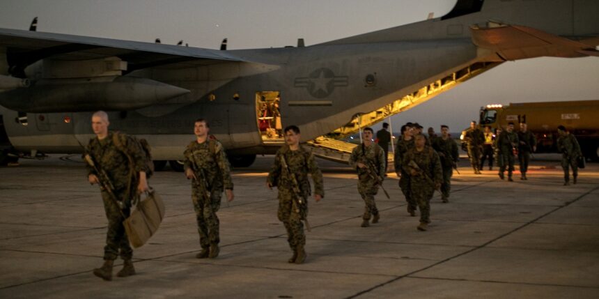 U.S. Marines with the 1st Battalion, 6th Marine Regiment, 2d Marine Division, disembark from a C-130 Hercules at Naval Station Guantanamo Bay, Cuba, on Feb. 1, 2025. The Marines have been deployed there as the Trump administration begins flights to Guantanamo Bay to detain up to 30,000 people who lack U.S. legal status. (U.S. Navy photo by Jovi Prevot)