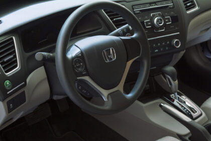 View of the steering wheel and dashboard of a Honda Civic 2014.